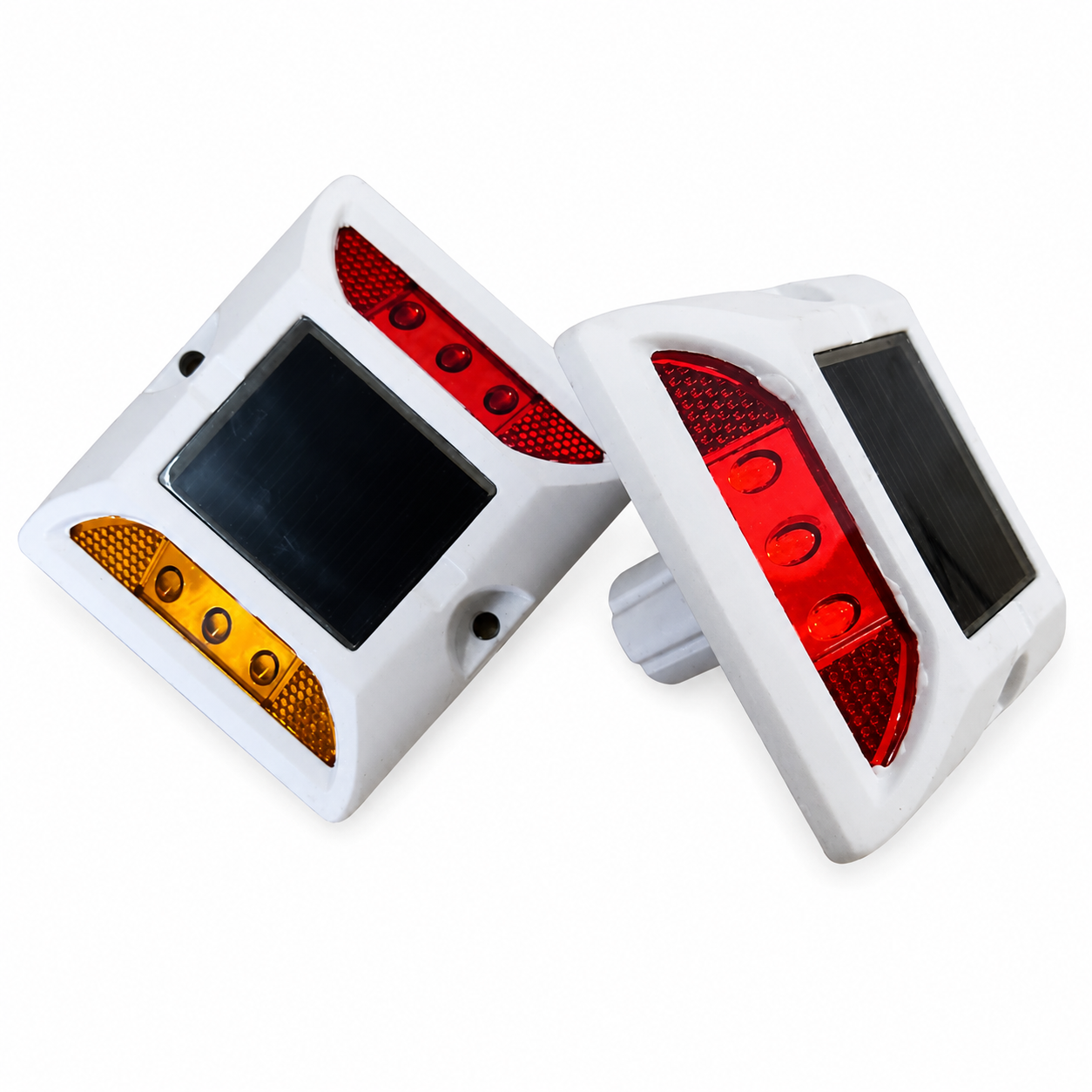 Two aluminium solar LED road studs on a white background