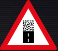 W325 Gravel Road Begins Ahead Sign